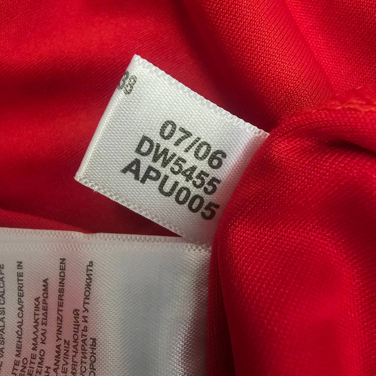Not genuine Adidas red shirt code tag showing GK9155